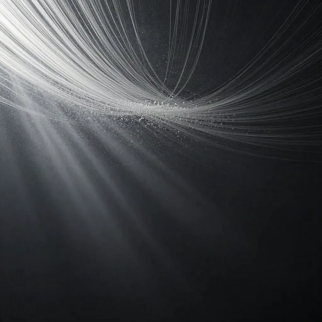 Silver filaments stream through charcoal haze into a soft off-centre bloom.